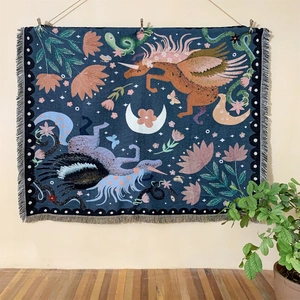 Unicorn bohemian woven cotton throw blanket with floral patterns and tassels on wall