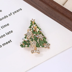 Macro detail of Christmas tree brooch with green enamel and sparkling crystal inlay