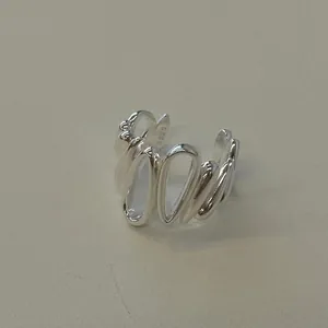 Detail view of the S925 sterling silver stamp on minimalist hollow oval ring