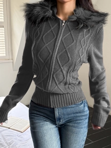 Detail of dark grey cable knit hoodie with faux fur trim and zip-up texture for women