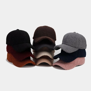 Collection of thick fleece baseball caps in nine solid colors stacked on white background