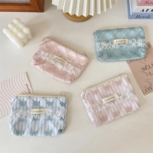 Detailed view of quilted lace coin purses in assorted floral and stripe patterns