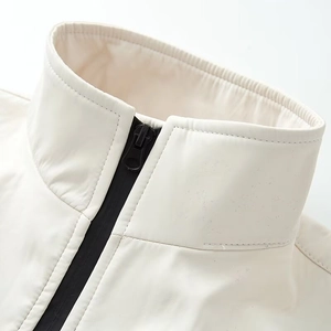 Creamy white waterproof ski jacket with stand collar and durable black zipper detail