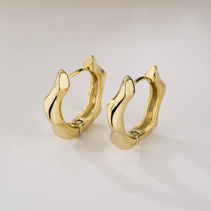 Minimalist irregular geometric golden earrings with polished metallic surface finish