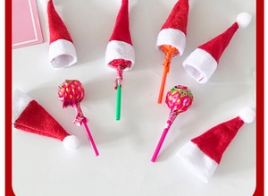 Mini Christmas lollipop hats made of red non-woven fabric for holiday candy decoration
