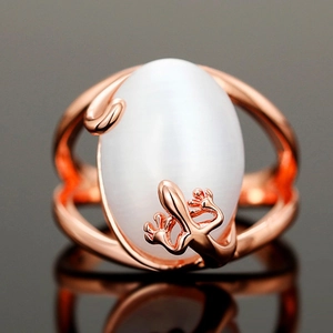Macro shot of rose gold lizard motif ring featuring a large white moonstone