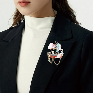 Enamel sailboat brooch with crystals, balloon accents and gold tassel on model