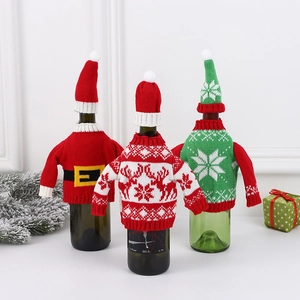 Three Christmas knitted wine bottle sweaters with Santa, reindeer and snowflake designs