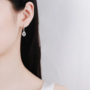 Elegant S925 sterling silver teardrop earrings with moissanite stones worn by model