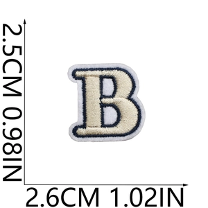 Detail of letter B embroidery patch with size measurements in cream and navy