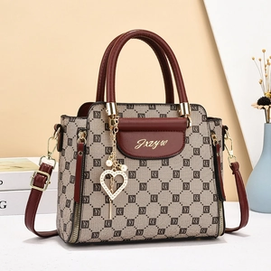 Elegant brown geometric monogram handbag with top handle and gold hardware accessories