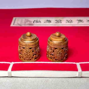 Detail of hand-carved green sandalwood sachets with hollow patterns and Zen calligraphy