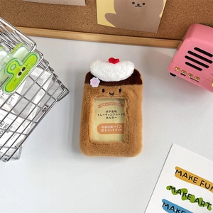 Detail view of pudding shaped plush photocard holder with soft brown fur and cream decoration