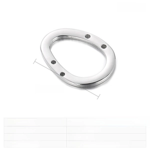 Macro detail of oval stainless steel accessory with four holes measuring 28x21mm