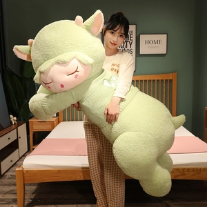 Giant green plush lamb in knitted sweater with Love text, shown in home setting