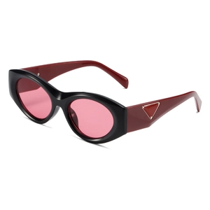 Fashion cat-eye sunglasses with black frames, wine red temples and pink tinted lenses