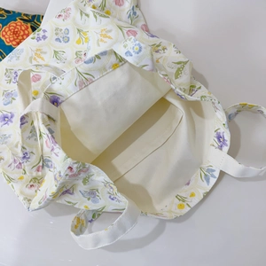 Detail view of floral canvas tote bag interior showing the inner pocket and lining