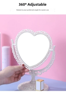 Close-up of vintage heart-shaped vanity mirror with carved floral relief and 360 rotation