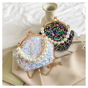 Detail of vintage sequin shell bags featuring pearl handle and metallic gold chain strap