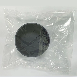 Close-up of a charcoal grey silicone protective sleeve for tumblers in plastic packaging