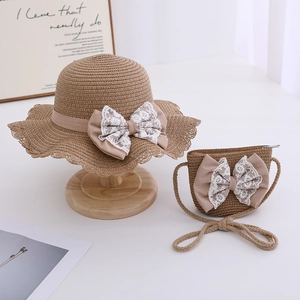 Kids straw sun hat and matching crossbody bag with pink lace bow and wavy brim