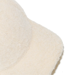 Close-up of soft plush texture on beige faux wool baseball cap for winter warmth
