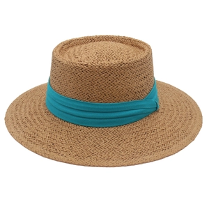 Flat top woven straw hat in natural brown with a wide peacock blue ribbon band