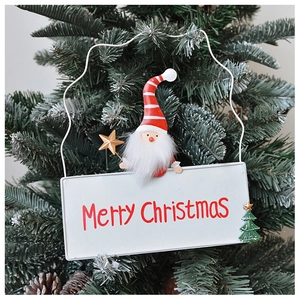 Detail of iron Christmas tree ornament featuring a Santa topper and Merry Christmas lettering