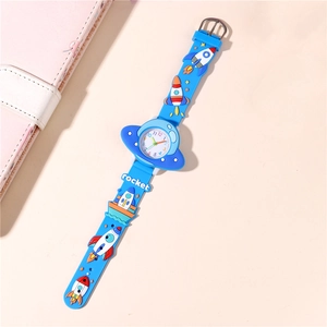 Detail showing the 3D rocket pattern on the soft blue silicone strap of this kids watch