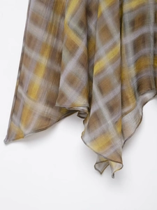Detailed macro view of yellow and grey plaid sheer fabric with fine edge stitching