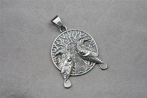 Detail shot of vintage silver Viking pendant with double eagles and Tree of Life motif