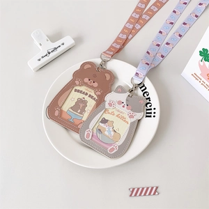 Detail view of cute cartoon puppy and cat PU leather card holders with lanyards