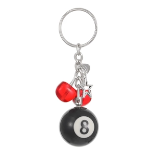 Detail of keychain featuring black 8 ball, red cherries and silver star charm pendant