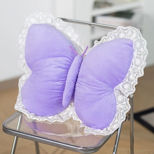 Detailed view of purple butterfly plush pillow featuring delicate white lace trimming