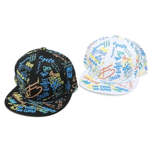 Detail of hip hop flat brim caps in black and white with vibrant graffiti prints