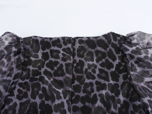 Detail shot of invisible zipper closure on the back of leopard print chiffon dress