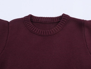 Detailed view of the crew neck and fine knit texture of this burgundy cropped sweater