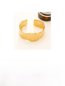 Detail of 18K gold-plated irregular hammer texture wide cuff bangle in stainless steel