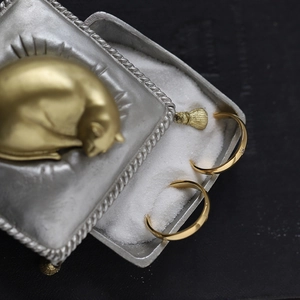 Macro shot of 18K gold plated celestial star and moon rings in a luxury gift box