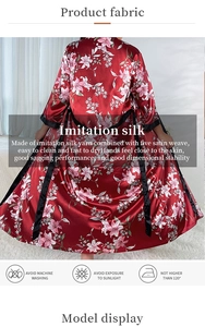 Detail of red floral satin bathrobe with premium lily print and black trim edge