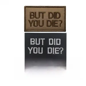 Detail shot of But Did You Die embroidered morale tactical patches in khaki and black