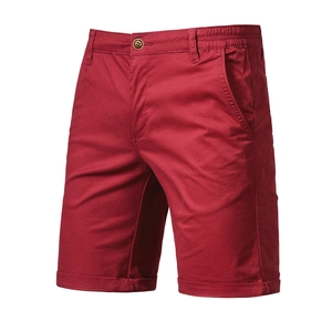 Detailed texture of red cotton casual shorts featuring a zip fly and button waist closure