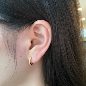 Elegant gold S925 silver hoop earrings with zircon stones shown on a female model