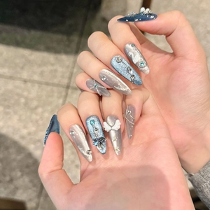 3D swan and angel wings nail charms on blue cat-eye press-on nails for women