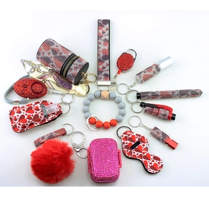 Detail view of red and pink self-defense keychain set with alarm and accessories