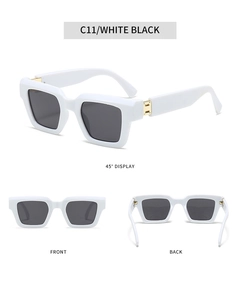 Detail view of square white sunglasses with dark lenses and gold metal accents