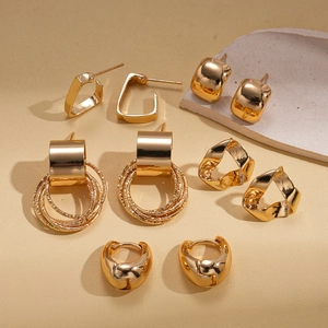Detail of 10-piece gold geometric stud earring set featuring polished and hammered textures
