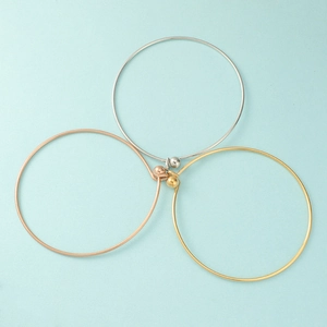 Detailed view of 60mm minimalist stainless steel bangles in gold, silver and rose gold