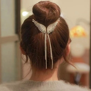 Silver wing hair clip with long tassel chains and rhinestones on back bun