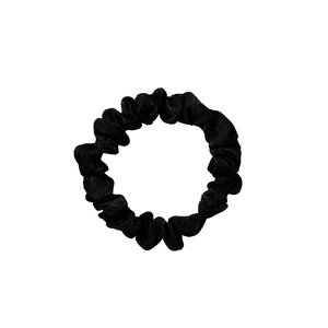 Classic black velvet scrunchie hair tie with soft fabric texture on white background